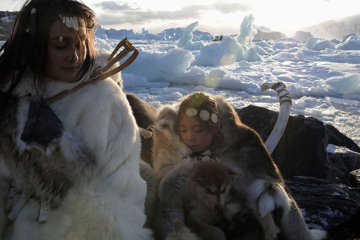 Mother and daughter with sled dogs in Uummannaq, Greenland  2009