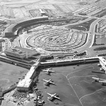 Aerial view of San Francisco International Airport (SFO) facing west toward International Terminal building (now Terminal 2) and ​​​​​​​South Terminal (replaced by Harvey Milk Terminal 1)  November 27, 1962